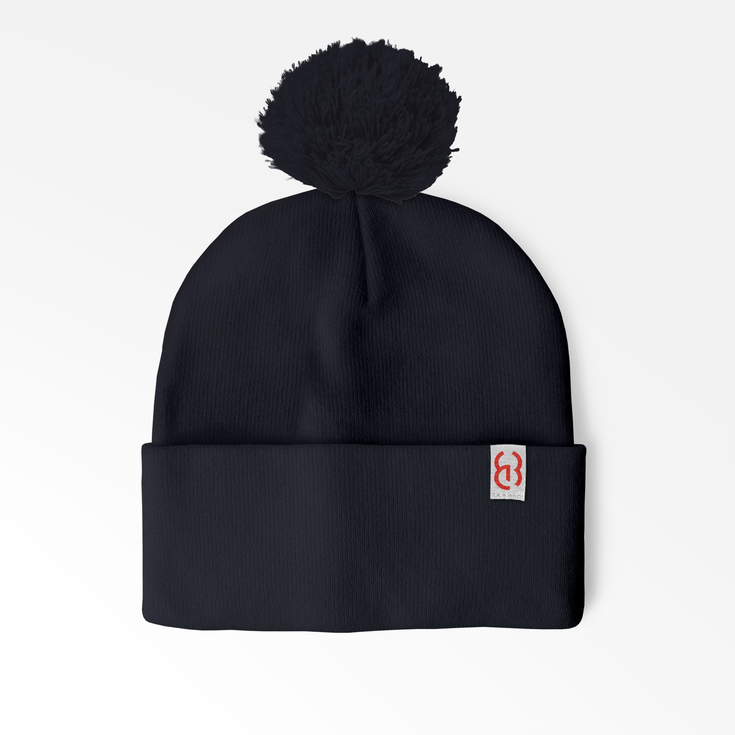 Cuffed Pom Beanie with sewn on embroidered tag