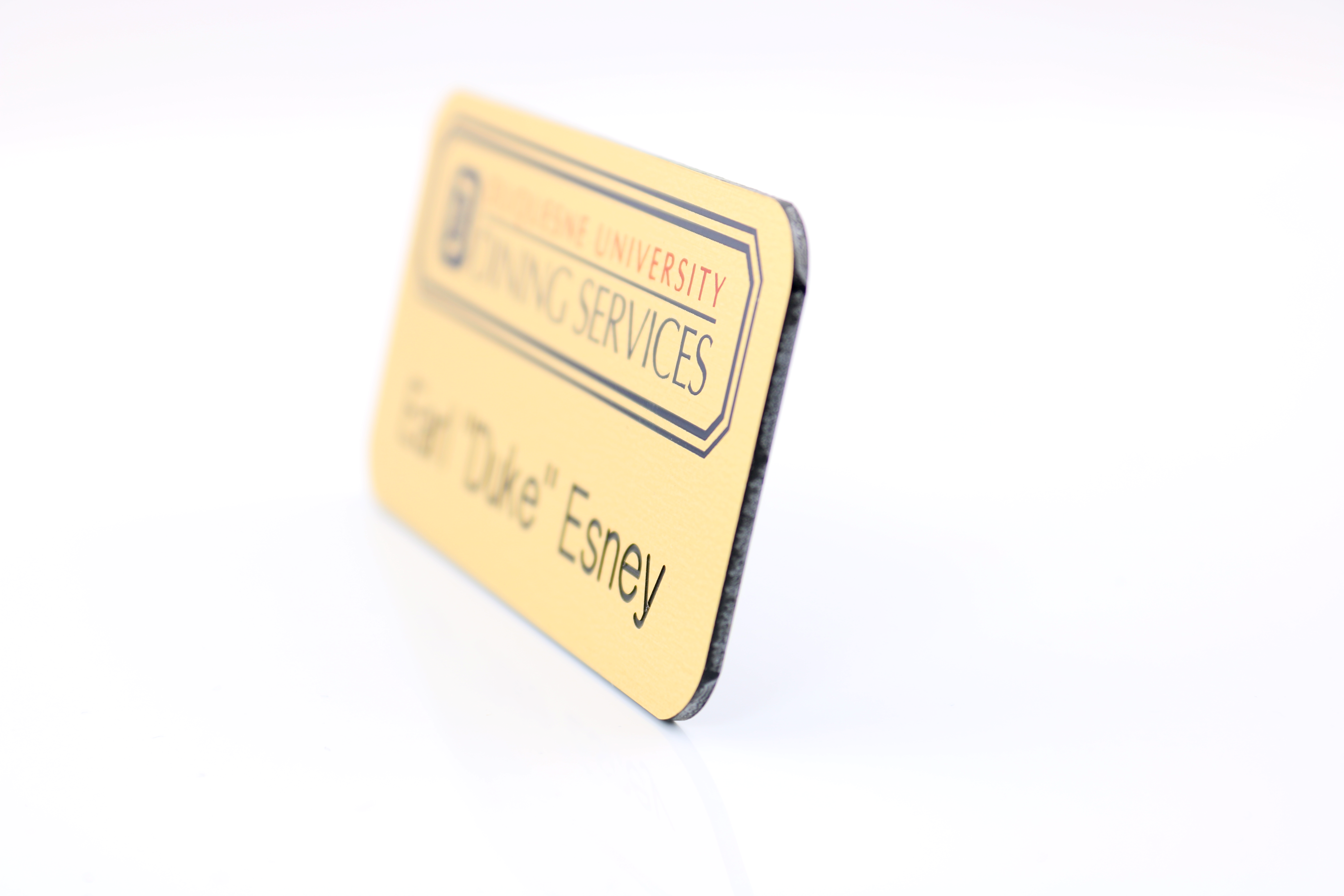 The Olympic UV Printed and engraved name badge on 2-ply  plastic up to 3 sq" 2